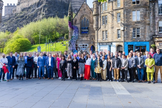 A photo of around 50 employees of Forrit standing outside in the sunshine in Edinburgh